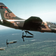 A US Air Force Corsair II drops Mark 82 bombs over a range in Floria
